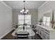 Dining room with decorative light fixture, a bright window, and elegant sideboard at 110 Legion Dr, Buford, GA 30518
