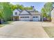 Traditional two-story home showing three-car garage, long driveway, basketball hoop, and landscaped front yard at 110 Legion Dr, Buford, GA 30518