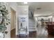 Inviting foyer featuring a staircase, hardwood floors, and an open view into the kitchen and living areas at 110 Legion Dr, Buford, GA 30518