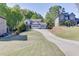 Inviting two-story home with a three-car garage, large driveway, and well-manicured lawn at 110 Legion Dr, Buford, GA 30518