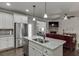 Open-concept kitchen flows into the living room, complete with stainless steel appliances and granite countertops at 110 Legion Dr, Buford, GA 30518