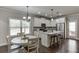 Modern kitchen island with white cabinets, seating, and adjacent eat-in kitchen at 110 Legion Dr, Buford, GA 30518