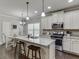 Modern kitchen featuring granite countertops, stainless steel appliances, and a functional island with bar stool seating at 110 Legion Dr, Buford, GA 30518