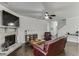 Well-lit living area with hardwood floors, a stone fireplace, and easy access to kitchen and stairway at 110 Legion Dr, Buford, GA 30518