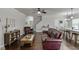 Bright living room with hardwood floors, open layout to dining area, and comfortable furnishings for relaxation at 110 Legion Dr, Buford, GA 30518