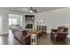 Spacious living room showcasing hardwood floors, a stone fireplace, and an open layout to the dining area at 110 Legion Dr, Buford, GA 30518
