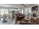 Open-concept living room with hardwood floors, a stone fireplace, and seamless flow to the kitchen and dining areas at 110 Legion Dr, Buford, GA 30518