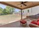 Relaxing covered patio with furniture, a ceiling fan, and a spacious backyard with a well-maintained fence at 110 Legion Dr, Buford, GA 30518