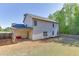 Two-story home with a patio, large yard, and mature trees, offering a perfect blend of indoor-outdoor living at 110 Legion Dr, Buford, GA 30518