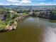 Scenic aerial view of a pristine lake surrounded by lush greenery and neighborhood at 203 Setters Rdg, Canton, GA 30115