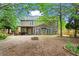 Spacious backyard with mature trees, fire pit, and covered deck; ideal for outdoor entertaining at 203 Setters Rdg, Canton, GA 30115