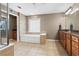 Relaxing bathroom with a soaking tub, walk-in shower, and granite counters at 203 Setters Rdg, Canton, GA 30115