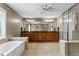 Main bathroom featuring double vanities, a soaking tub, and a separate glass shower at 203 Setters Rdg, Canton, GA 30115