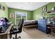 A bedroom with green walls, a bed, and two computer setups provides a fun and functional space at 203 Setters Rdg, Canton, GA 30115