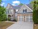 Beautiful home with well-maintained lawn, stone accents, and modern garage doors at 203 Setters Rdg, Canton, GA 30115