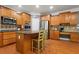 A well-designed kitchen with hardwood floors, ample cabinet space, and a functional island at 203 Setters Rdg, Canton, GA 30115