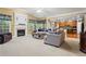 Bright, open living room with a fireplace, large windows, and a seamless flow to the kitchen at 203 Setters Rdg, Canton, GA 30115