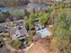 Aerial view of a community clubhouse and pool with mature trees, lawns and landscaping at 203 Setters Rdg, Canton, GA 30115