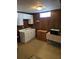 Finished basement with white cabinets, dark wood paneling, and a small window at 2126 Monterey Dr, Snellville, GA 30039