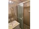 Functional bathroom featuring a walk-in shower with sliding doors and a neutral color scheme at 2126 Monterey Dr, Snellville, GA 30039