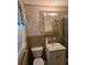 Traditional bathroom with tile walls, a toilet, vanity, and a shower featuring sliding glass doors at 2126 Monterey Dr, Snellville, GA 30039