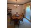 View of a traditional dining room with vintage-style wallpaper and light fixture at 2126 Monterey Dr, Snellville, GA 30039
