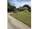 Long driveway leading to a brick home with attached garages and landscaped front yard at 2126 Monterey Dr, Snellville, GA 30039