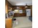 Kitchen featuring wood cabinets, white appliances, and light flooring at 2126 Monterey Dr, Snellville, GA 30039