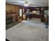 Open concept living room and kitchen space with carpet and wood paneling at 2126 Monterey Dr, Snellville, GA 30039