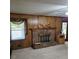 Cozy living room featuring wood paneling and a brick fireplace, creating a warm and inviting atmosphere at 2126 Monterey Dr, Snellville, GA 30039