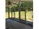 Bright sunroom with multiple sliding glass doors offering views of the backyard and lush greenery at 2126 Monterey Dr, Snellville, GA 30039