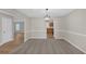 Spacious dining room with neutral carpet, modern lighting, flowing into the kitchen with wood floors at 2640 Thunder Basin Way, Douglasville, GA 30135