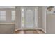 Bright entryway featuring a white front door with sidelights, leading to a carpeted living area with natural light at 2640 Thunder Basin Way, Douglasville, GA 30135