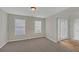Inviting living room with neutral carpet, light gray walls, and a bright window for ample natural light at 2640 Thunder Basin Way, Douglasville, GA 30135