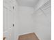 Spacious walk-in closet with neutral carpet, white walls and door, and a wire shelf for storing items at 2640 Thunder Basin Way, Douglasville, GA 30135