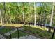 Beautiful landscaped backyard with a staircase leading down to a serene water view, blending nature and design at 3290 Dunlop Ne Ct, Atlanta, GA 30319