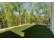 Artificial grass yard with railings showing off the property's serene, wooded backdrop at 3290 Dunlop Ne Ct, Atlanta, GA 30319