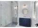 Bathroom featuring navy blue vanity with marble countertop and glass-enclosed shower at 3290 Dunlop Ne Ct, Atlanta, GA 30319