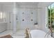 Bright bathroom featuring a large shower with a glass enclosure, a modern tub, and elegant fixtures at 3290 Dunlop Ne Ct, Atlanta, GA 30319