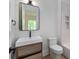 Modern bathroom with wood vanity, stylish black fixtures and white subway tiles in the shower at 3290 Dunlop Ne Ct, Atlanta, GA 30319