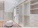 Well-organized walk-in closet with custom shelving, drawers, and a central ottoman at 3290 Dunlop Ne Ct, Atlanta, GA 30319