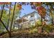 Three story home featuring multiple decks with black railings surrounded by trees at 3290 Dunlop Ne Ct, Atlanta, GA 30319