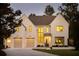 Elegant two-story home with a two-car garage, well-lit windows, and manicured landscaping at 3290 Dunlop Ne Ct, Atlanta, GA 30319