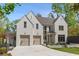 Stunning white brick home with a two-car garage and circular driveway, surrounded by lush greenery at 3290 Dunlop Ne Ct, Atlanta, GA 30319