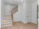 Bright foyer featuring light wood flooring and a modern staircase with a black iron railing at 3290 Dunlop Ne Ct, Atlanta, GA 30319