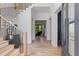 Welcoming foyer with hardwood floors, staircase, and a view to the living area through glass paneled doorway at 3290 Dunlop Ne Ct, Atlanta, GA 30319