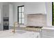 A luxury gourmet kitchen with stainless steel appliances, white cabinets, and stone backsplash at 3290 Dunlop Ne Ct, Atlanta, GA 30319