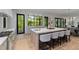 Gourmet kitchen with oversized island, stainless appliances, white cabinets, stone countertops, and breakfast bar at 3290 Dunlop Ne Ct, Atlanta, GA 30319