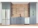 Modern kitchenette features sleek gray cabinets, stainless appliances, and stylish wood backsplash with glass shelving at 3290 Dunlop Ne Ct, Atlanta, GA 30319