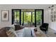 Chic living room showcases natural light and flows seamlessly to an outdoor patio with gorgeous green views at 3290 Dunlop Ne Ct, Atlanta, GA 30319
